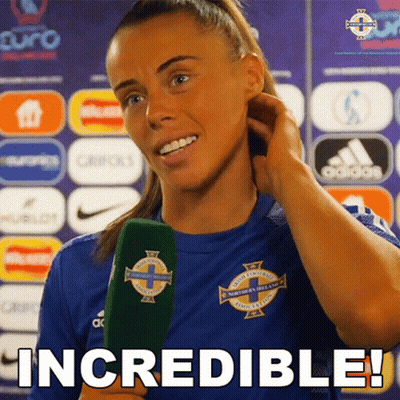 Woman In Blue Shirt Holding Green Microphone Says Incredible GIF