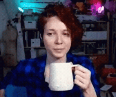 Woman In Blue Shirt Holding White Mug GIF