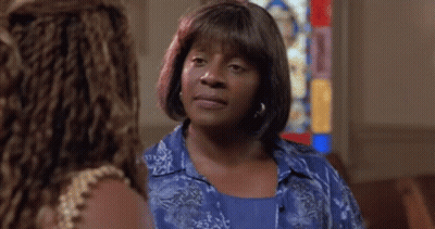 Woman In Blue Shirt In Church With Stained Glass Window GIF