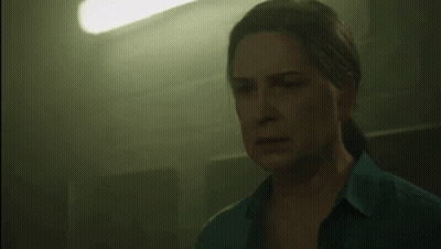 Woman In Blue Shirt In Dark Room With Green Light GIF