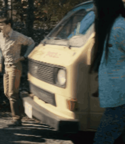 Woman In Blue Shirt In Front Of DHL Van GIF