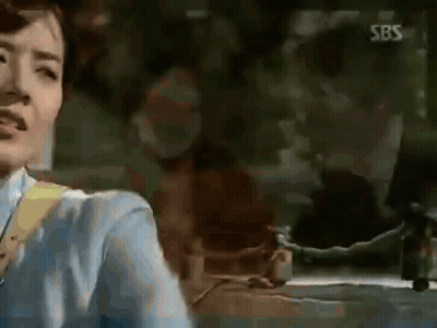 Woman In Blue Shirt In Front Of SBS Sign GIF