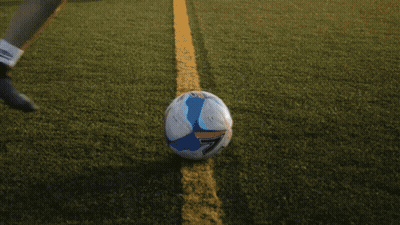 Woman In Blue Shirt Kicking Soccer Ball GIF