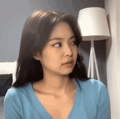 Woman in Blue Shirt Looking at Camera