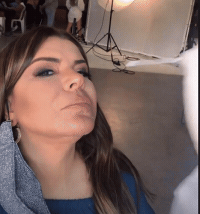 Woman In Blue Shirt Looking Down GIF