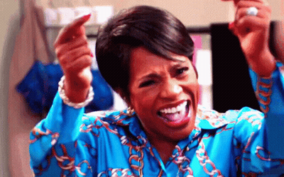 Woman In Blue Shirt Making Funny Face Pointing GIF