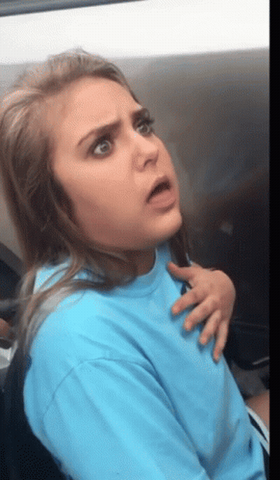 Woman In Blue Shirt Making Funny Face GIF