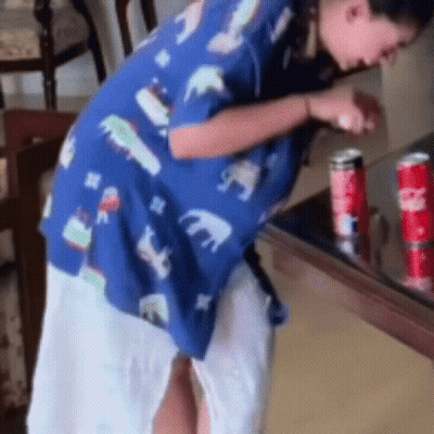 Woman In Blue Shirt Next To Coca Cola GIF