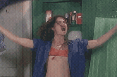 Woman In Blue Shirt, Red Bra, Arms Outstretched GIF