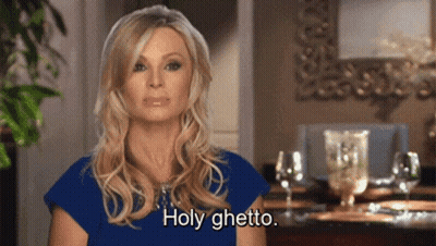Woman In Blue Shirt Saying Holy Ghetto With Wine Glasses GIF