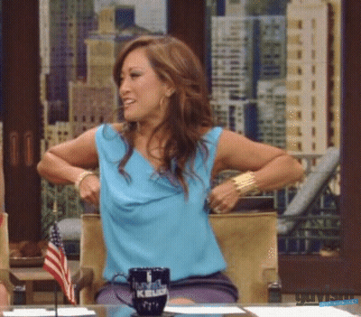 Woman In Blue Shirt Sitting At Table With Kelly Mug GIF