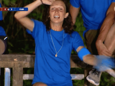 Woman In Blue Shirt Sitting On Bench With Hands Up And Scoreboard Saying Plavi GIF