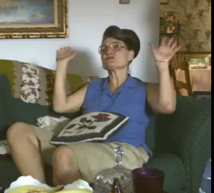 Woman In Blue Shirt Sitting On Couch GIF