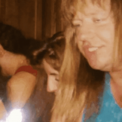 Woman In Blue Shirt Smiling At Another Woman GIF