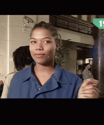 Woman In Blue Shirt Standing In Front Of Camera GIF