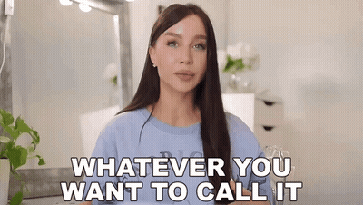 Woman In Blue Shirt Standing In Front Of Mirror GIF