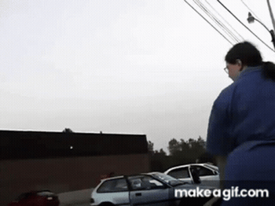 Woman In Blue Shirt Standing In Front Of White Car GIF