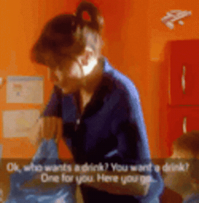 Woman In Blue Shirt Talking To Child Wanting Drink GIF