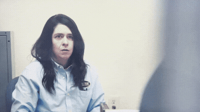 Woman In Blue Shirt With AJ Badge GIF