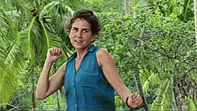 Woman In Blue Shirt With Arms Outstretched In Jungle GIF