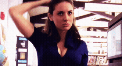 Woman In Blue Shirt With Hand In Hair Library GIF