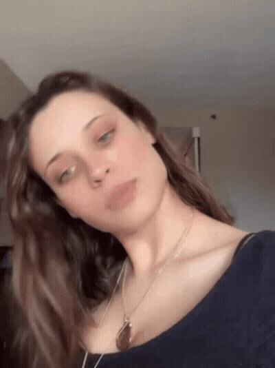 Woman In Blue Shirt With Necklace GIF