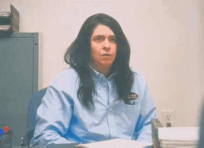 Woman In Blue Shirt With Prison Badge GIF