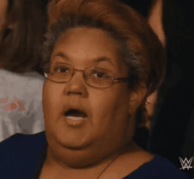 Woman In Blue Shirt With Wrestling Logo GIF