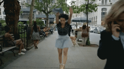 Woman In Blue Skirt Running Down Street GIF