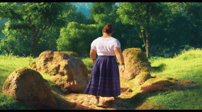 Woman In Blue Skirt Walking Through Grassy Field GIF