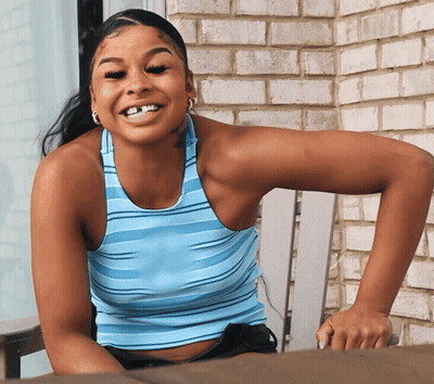 Woman In Blue Striped Tank Top Smiling In Chair GIF
