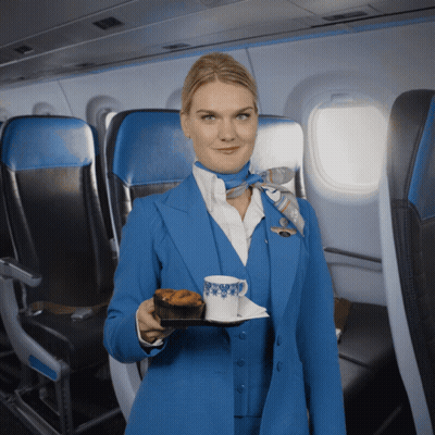 Woman in Blue Suit Holding Food and Coffee