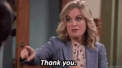 Woman In Blue Suit Pointing Saying Thank You GIF