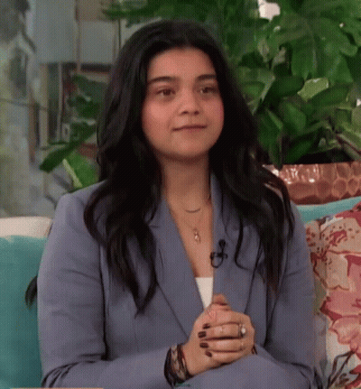 Woman In Blue Suit Sitting On Couch Smiling GIF