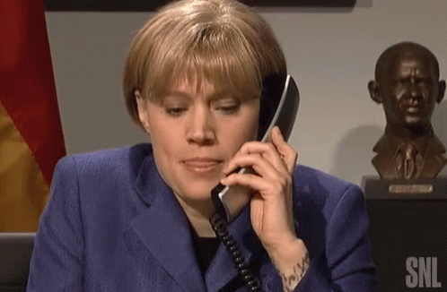 Woman In Blue Suit Talking On Phone GIF