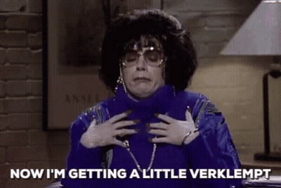 Woman In Blue Sweater And Sunglasses Holding Chest GIF