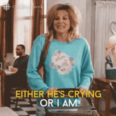 Woman In Blue Sweater Holding Bag Says Either He's Crying Or I Am GIF