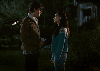 Woman In Blue Sweater Kissing Man In Brown Jacket GIF