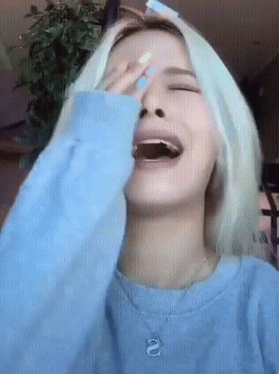 Woman In Blue Sweater Laughing Covering Face GIF