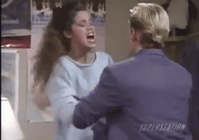 Woman In Blue Sweater Screaming At Man In Suit GIF