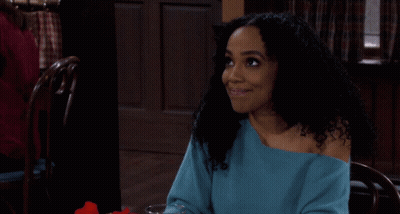 Woman In Blue Sweater Sitting At Table With Wine GIF