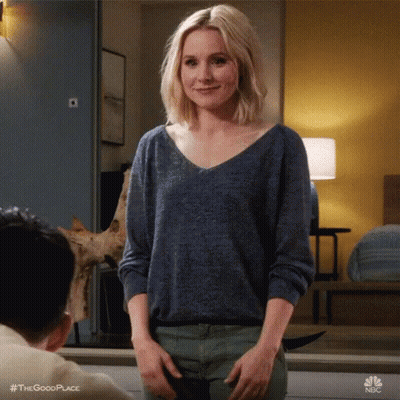 Woman In Blue Sweater Standing In Front Of Man GIF