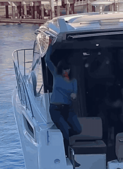 Woman In Blue Sweater Standing On Boat GIF