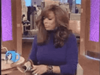 Woman In Blue Sweater With Coffee And Magazine GIF