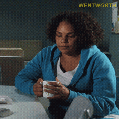 Woman In Blue Sweatshirt Holding Cup GIF