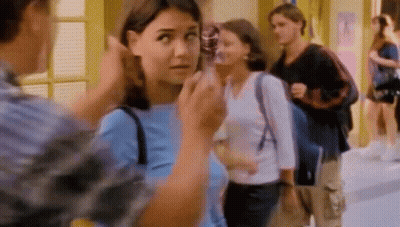 Woman In Blue Talking To Man In Plaid GIF