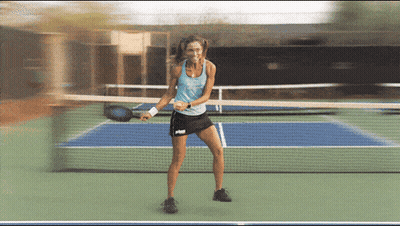 Woman In Blue Tank Top And Black Skirt Holding Tennis Racquet GIF