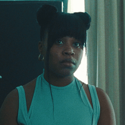 Woman In Blue Tank Top And Hoop Earrings GIF