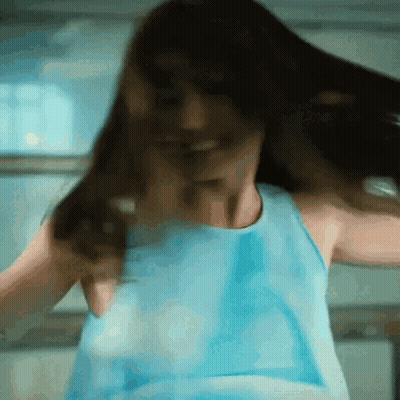 Woman In Blue Tank Top Dancing With Hair Flying GIF