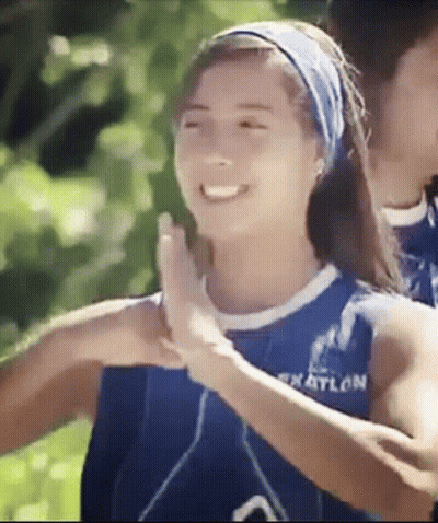Woman In Blue Tank Top High-Fiving Another Woman GIF